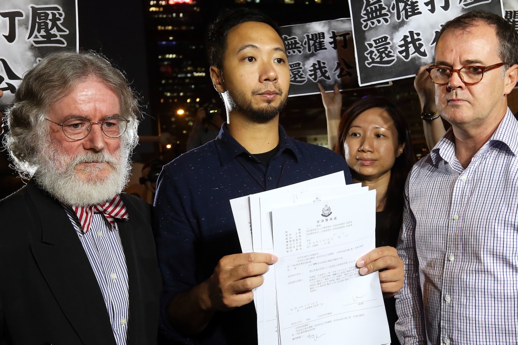 Pro-democracy activist Ken Tsang Kin-chiu (centre), who was allegedly beaten by seven police officers during the Occupy protests one year ago, meets the press as he leaves with his legal advisors at Central Police Station. Photo: Dickson Lee