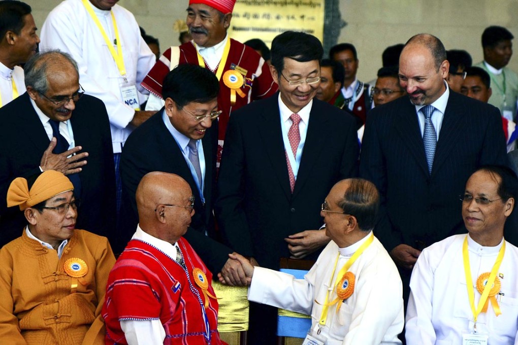 Myanmar president Thein Sein (second right) greets Chinese Ambassador to Myanmar Hong Liang (back, second right) during a ceasefire ceremony in Naypyitaw. Photo: EPA