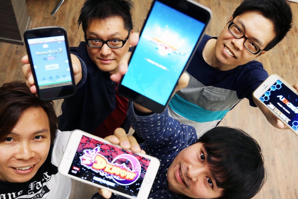 Clockwise from left, William Ng, co-founder of Fight4Dream Studio; Dixon Cheung, chairman of Fingerprint Studio; Alvin Wong, co-founder of Fight4Dream Studio; and Edward Li, CEO and co-founder of Twitchy Finger, showing off their smartphone games. Photo: Felix Wong
