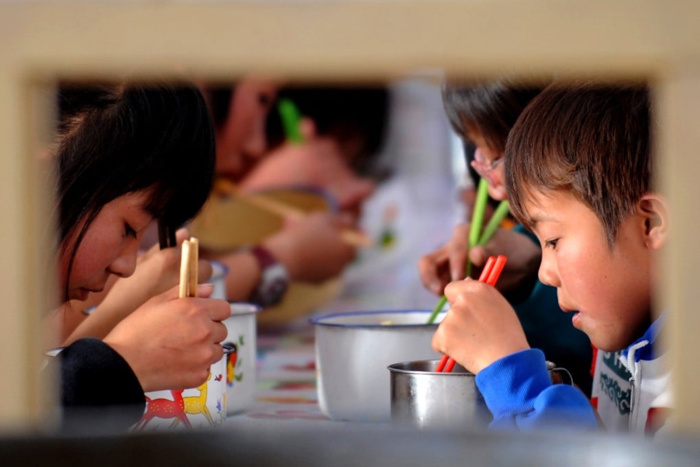 Rural children eat during a lunch break at their boarding school in Lanzhou, Gansu. Study after study shows that financial and in-kind aid reduces poverty. Photo: Xinhua