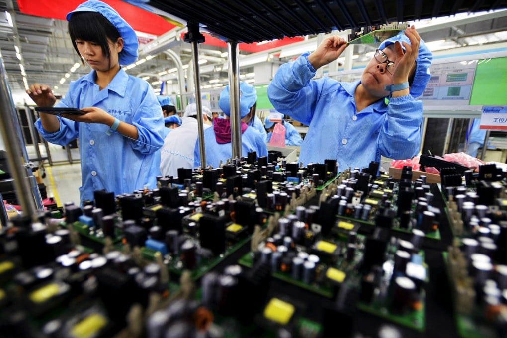 Chinese employees work at a production line of electronic panels. Photo: Reuters