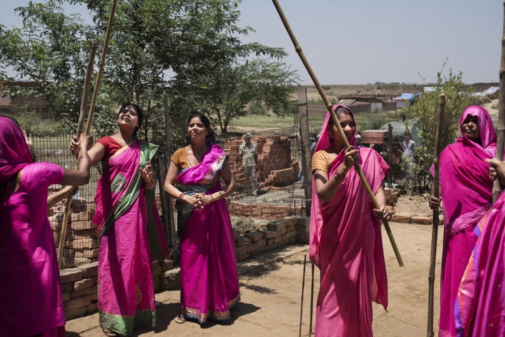 Gulabi Gang members practise wielding their bamboo sticks. Photos: Zigor Aldama; Miguel Candela