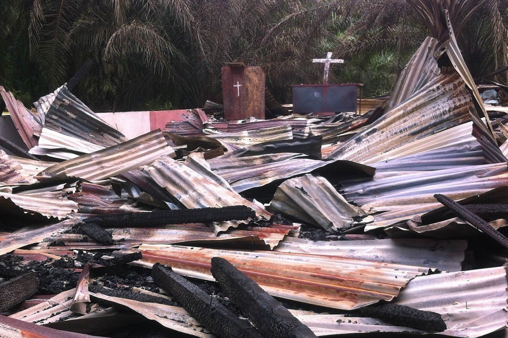 Tensions are running high after hundreds of armed men burned down this tiny church in Aceh. Photo: AFP