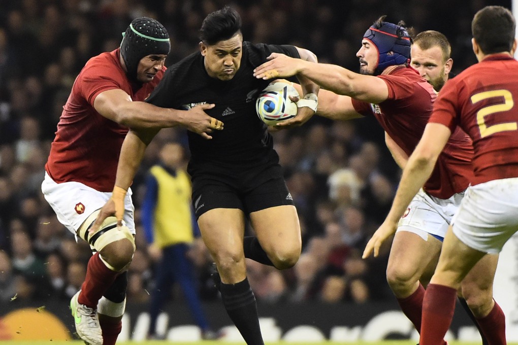 New Zealand's hat-trick hero Julian Savea breaks through the French defence. Photo: AFP