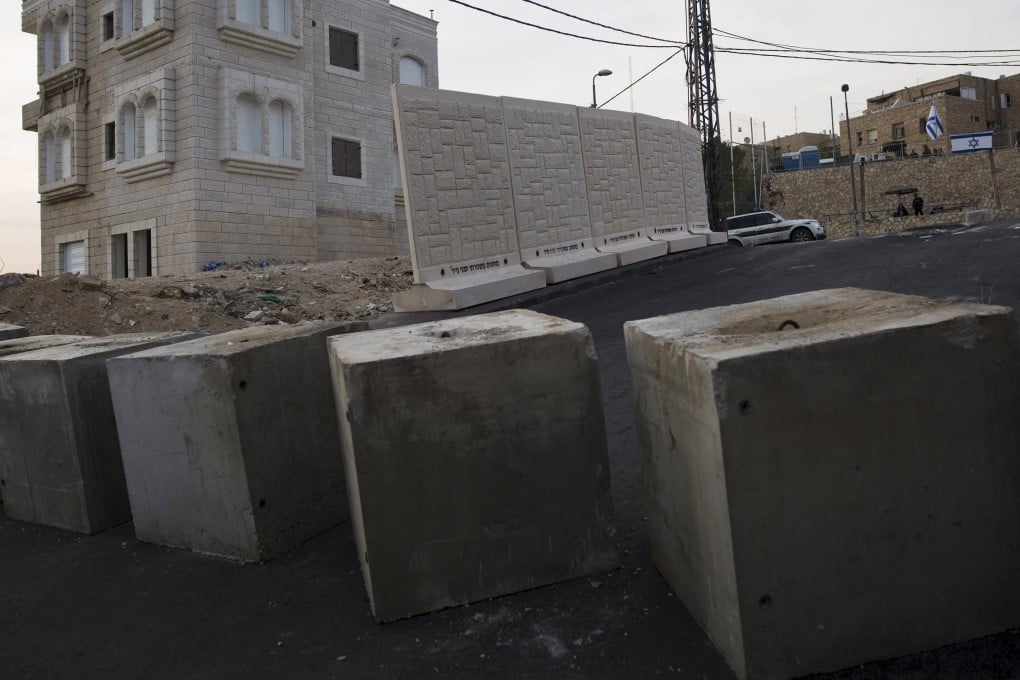 A street view shows concrete cubes, a newly erected temporary concrete wall that measures around 10 metres, in Jerusalem. Photos: Reuters