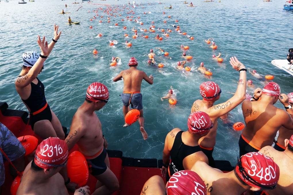 Swimmers dive in for the 2015 Harbour Race. Photo: Sam Tsang