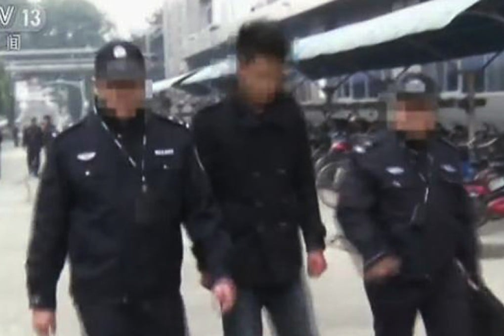 Police officers flank one of the suspects in the case. Photo: CCTV