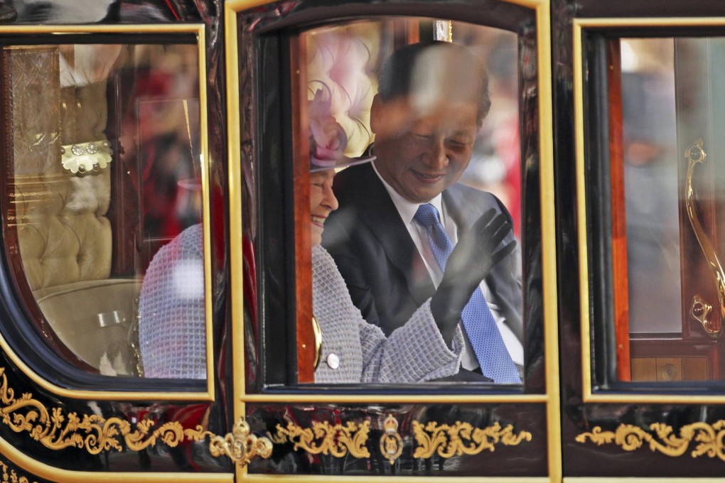 President Xi Jinping and Britain's Queen Elizabeth share a moment in their gilded carriage on the way to Buckingham Palace in London yesterday. Photo: Reuters