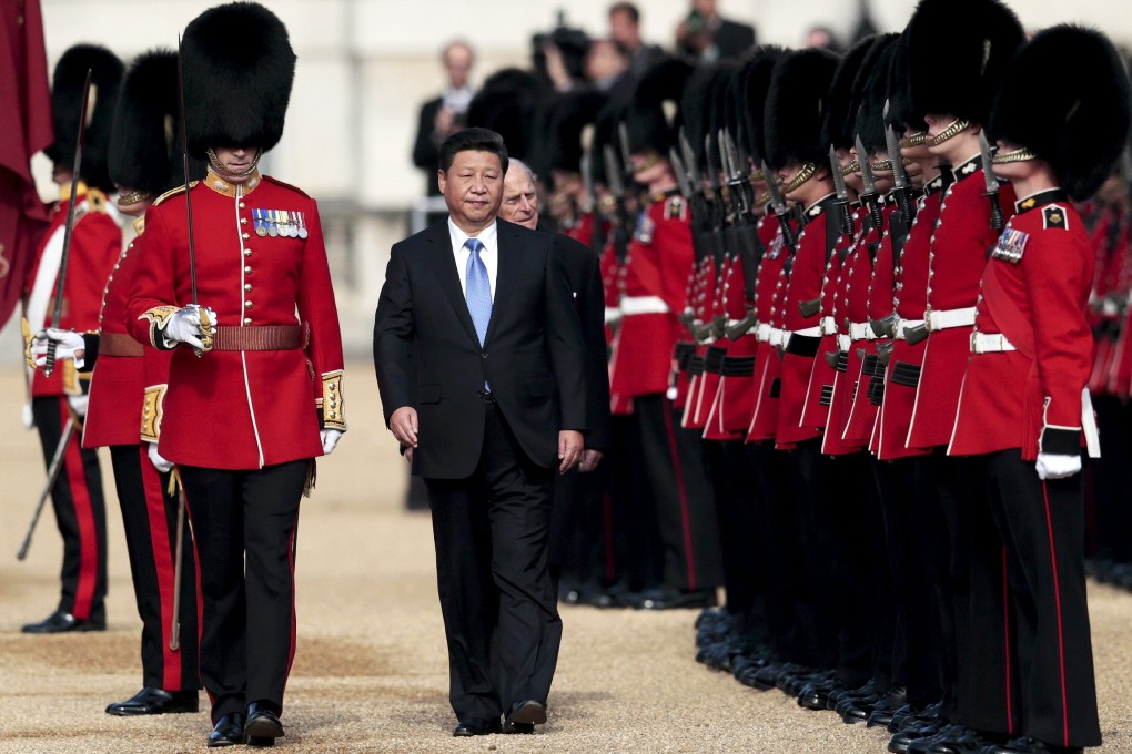 President Xi Jinping and Britain's Prince Philip review an honour guard during the official welcoming ceremony for the Chinese leader in London on Tuesday. Photo: Reuters