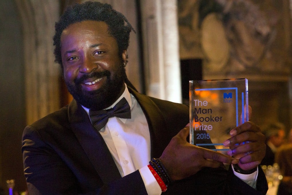 Marlon James poses with his prize at London's Guildhall. He destroyed the manuscript of his first novel and briefly stopped writing after scores of rejections from publishers. Photo: Reuters