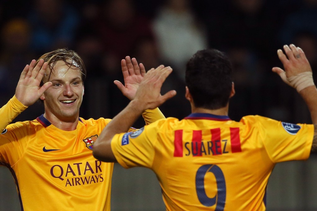 Ivan Rakitic and Luis Suarez celebrate. Photo: AFP