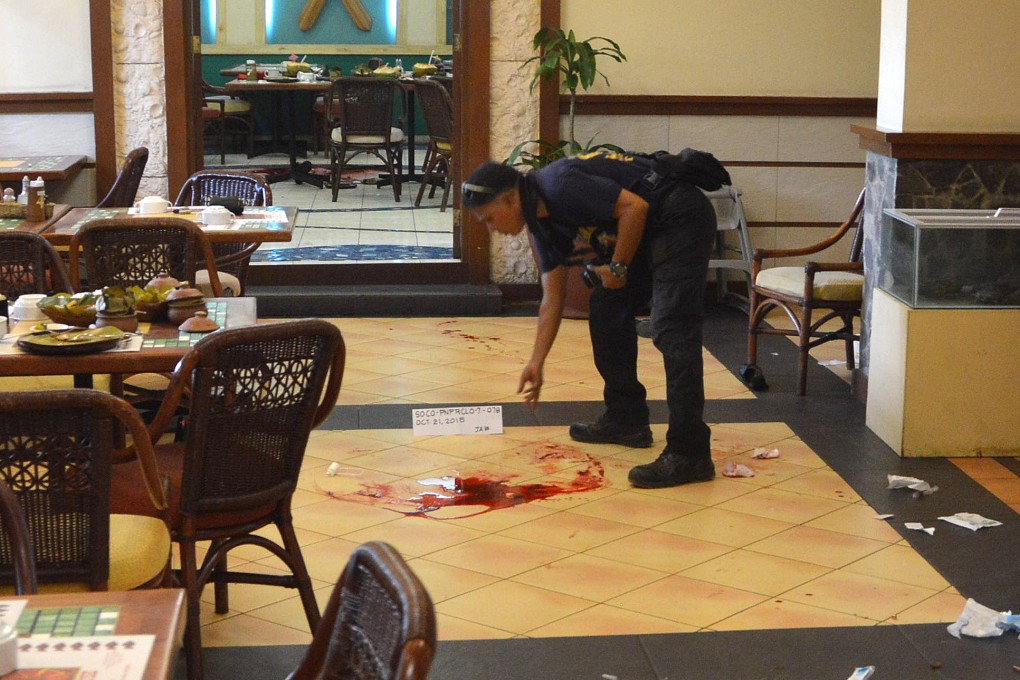 An investigator marks the crime scene where the two people were killed inside the Lighthouse Restaurant. Photo: AP