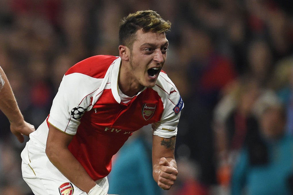 Mesut Ozil celebrates his late goal. Photo: Reuters