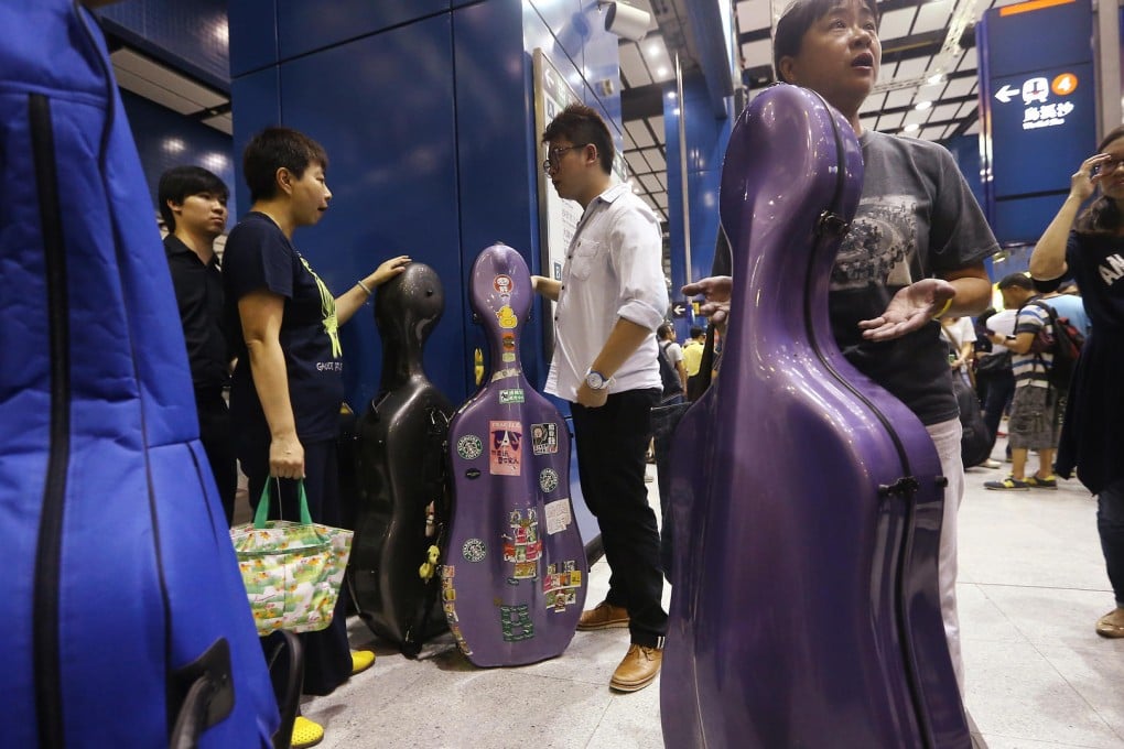 Musicians stage a protest at Tai Wai station over the MTR's apparent double standards. Photo: Sam Tsang