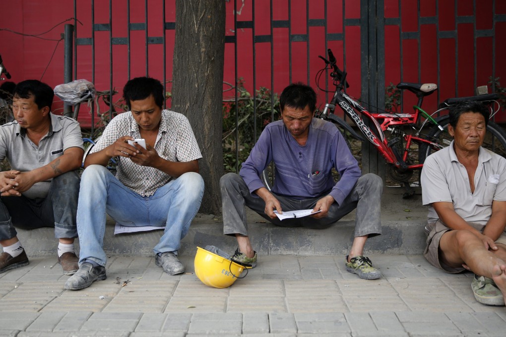 Chinese migrant workers workers that have lived in adopted cities for many years are not entitled to the same benefits as locals because they do not have a household registration for their new places of residence. Photo: EPA