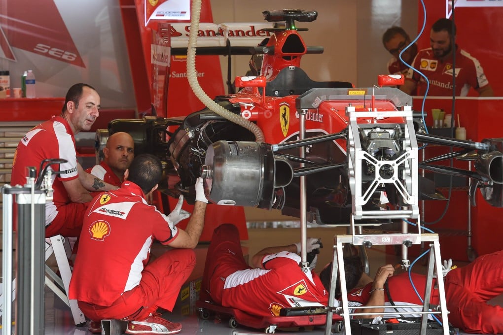 Pit crew work on Sebastian Vettel's Ferrari at the Circuit of the Americas. Photo: AFP