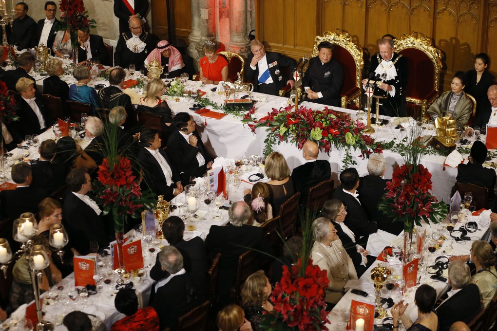 President Xi Jinping listens to The Lord Mayor of London Alan Yarrow make a speech during a banquet at Guildhall in London on Wednesday. Photo: AP