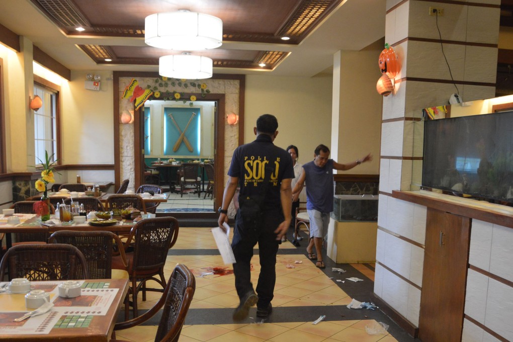 A police investigator inspects the crime scene where Chinese consul general Song Ronghua was wounded after a shooting incident at a restaurant, in Cebu City, central Philippines. Photo: AFP