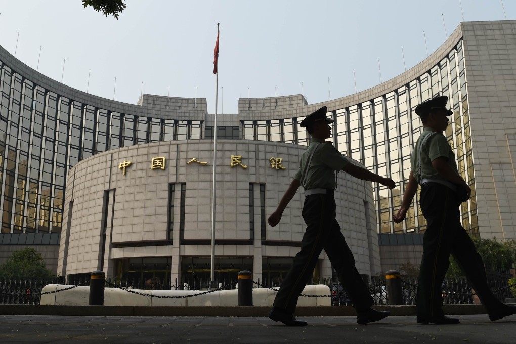 Paramilitary policemen patrol in front of the People's Bank of China, China's central bank, in Beijing. Photo: AFP
