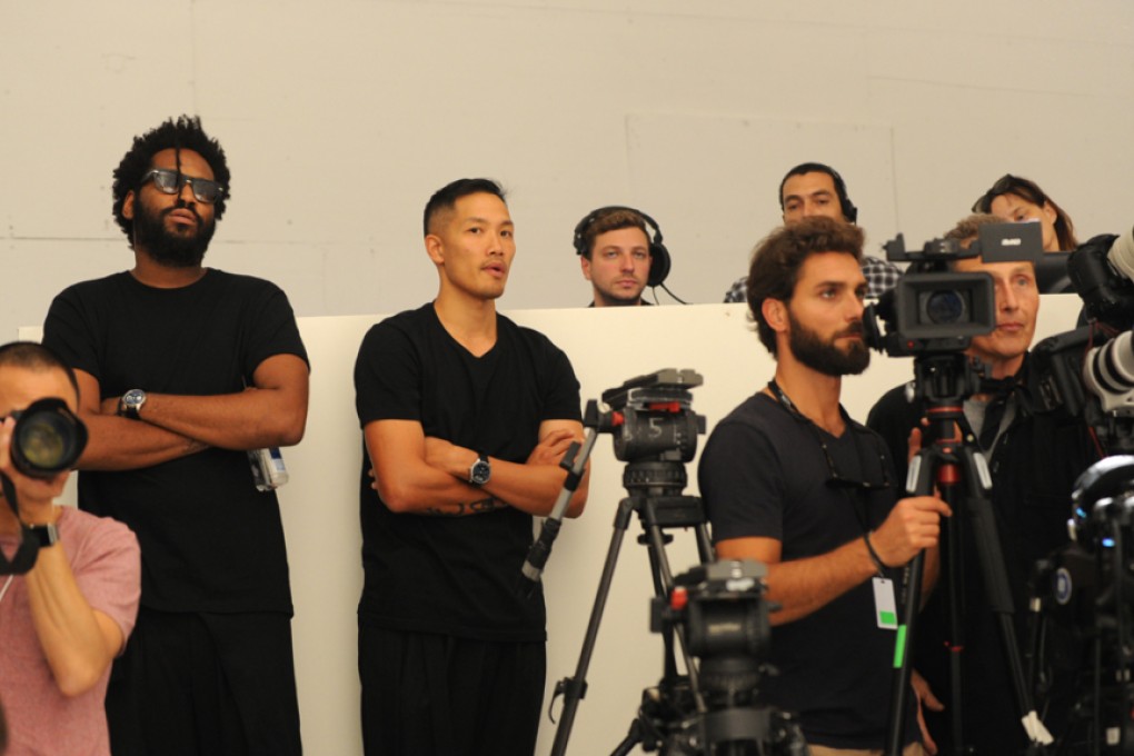 Maxwell Osborne (left) and Dao-Yi Chow (centre) watch a rehearsal of their DKNY show at New York Fashion Week.