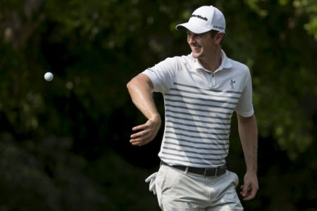 Justin Rose catches a ball thrown by his caddie at Fanling on Thursday. Photo: K.Y. Cheng