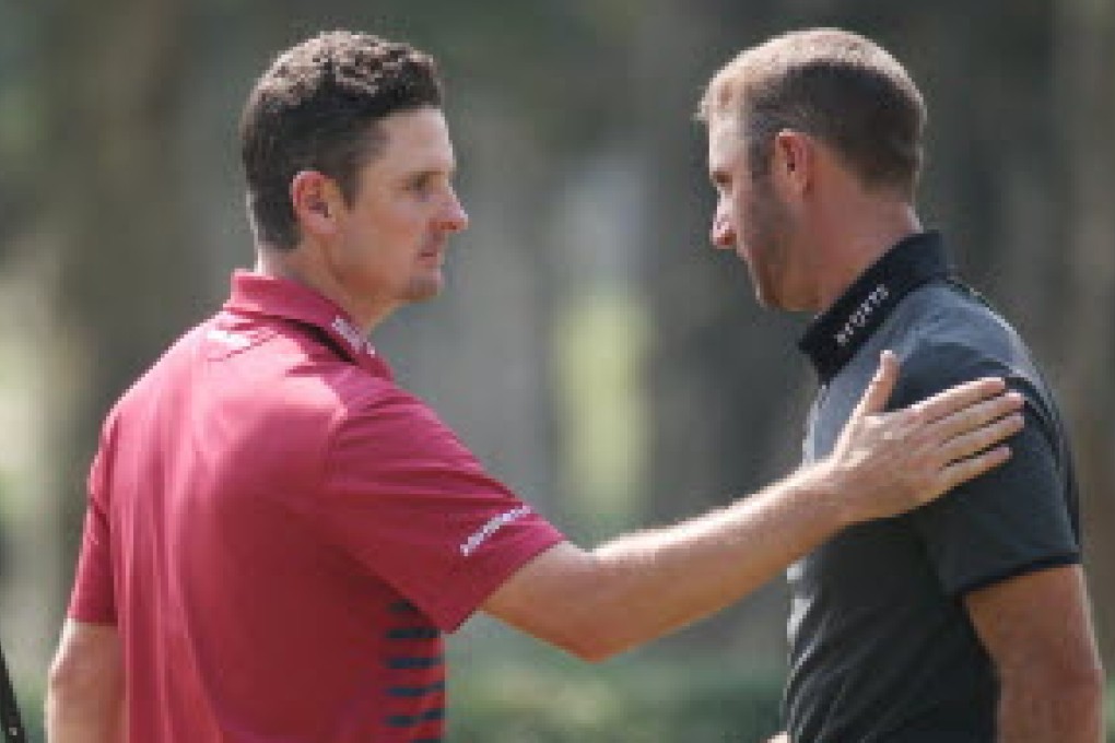 Justin Rose pats Dustin Johnson on the shoulder after they finished their round on Friday. Photo: AP