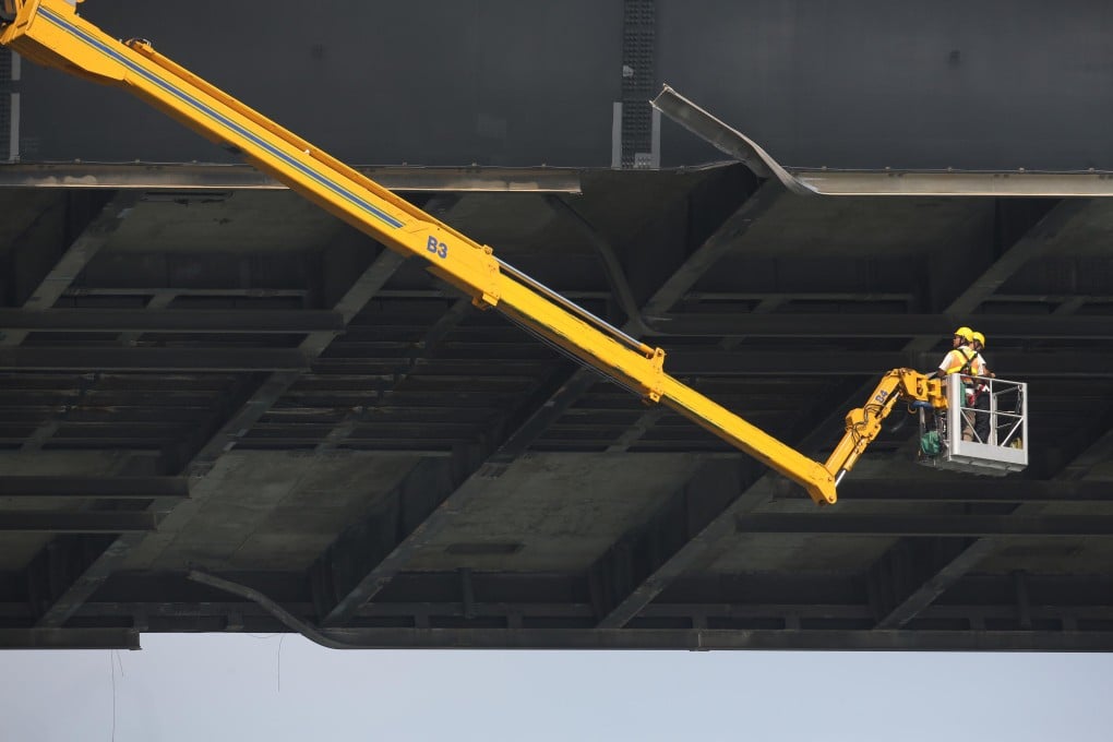 Workers inspect the underside of Kap Shui Mun Bridge after the vessel tore into it on Friday evening. SCMP Pictures