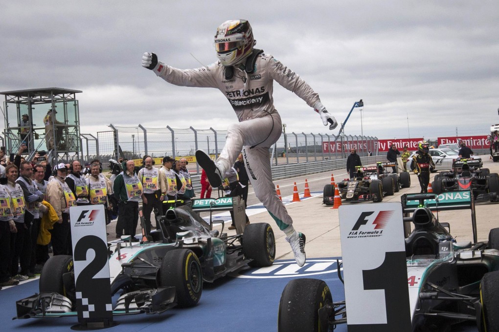 Lewis Hamilton leaps from his car after his win. Photo: Reuters