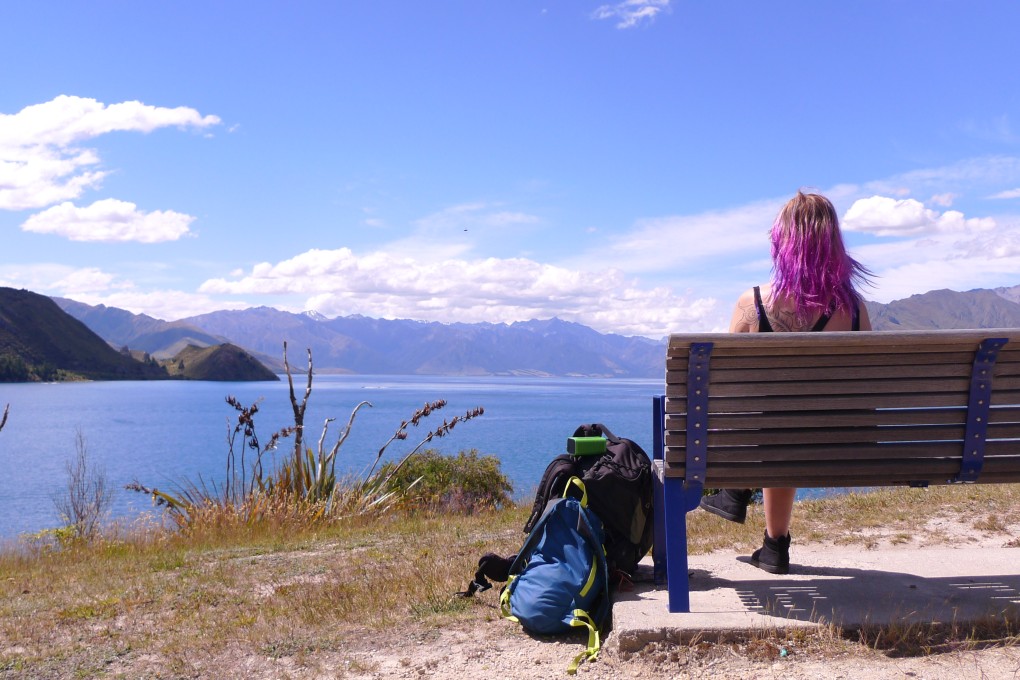 A solo woman traveller enjoys Lake Hawea in New Zealand. Photo: Danielle Ditzan (likeridingabicycle.com)