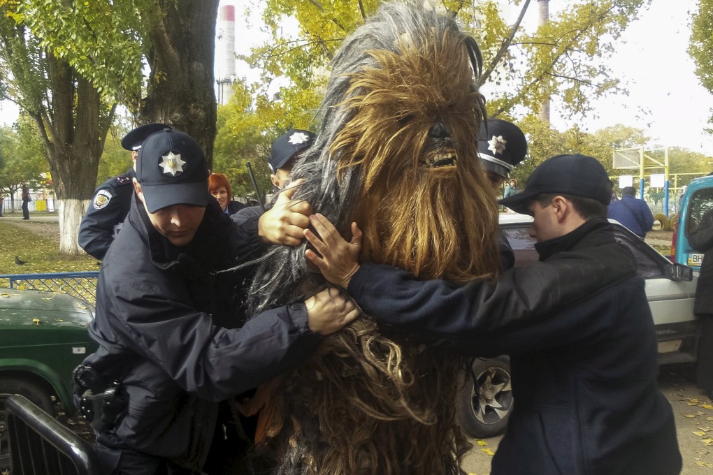 Chewbacca resisted four law enforcement officers, who were forced to pin him down on the hood of a van to handcuff him. Photo: Reuters