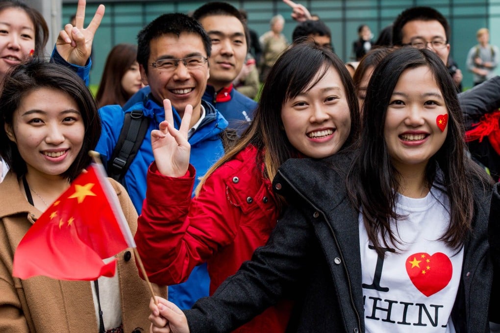 Chinese students show support for President Xi Jinping as he arrives at Manchester University in Britain last week. Photo: AFP
