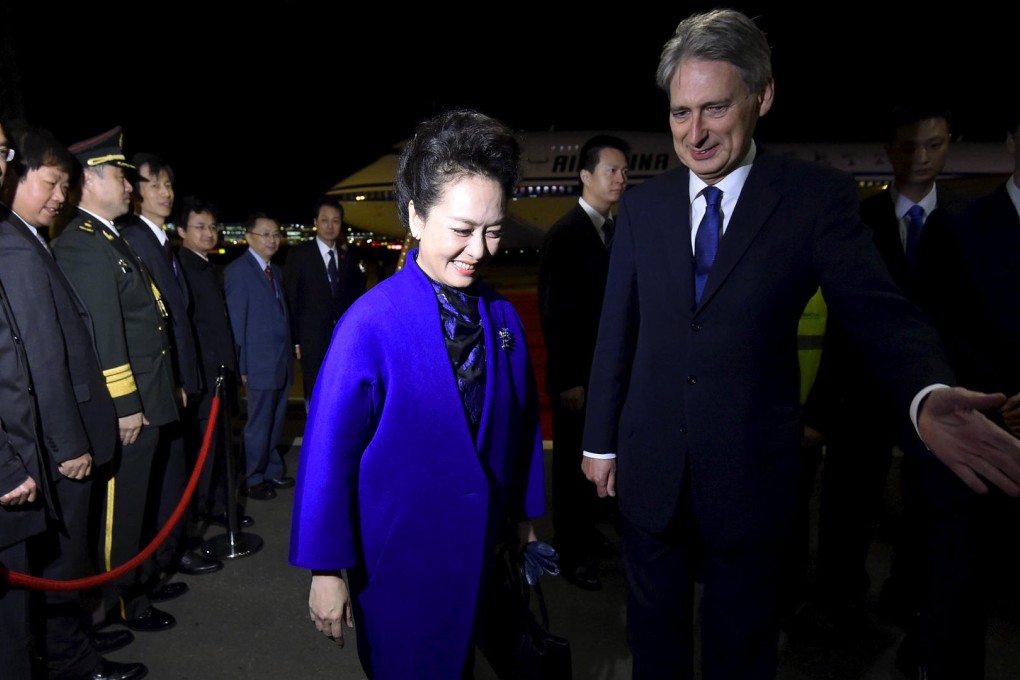 Peng Liyuan, wife of President Xi Jinping, was welcomed by British Foreign Secretary Philip Hammond during their state visit to the UK. In September, Hammond hailed a reform to Japan's self-defence laws that incensed Beijing. Photo: AP