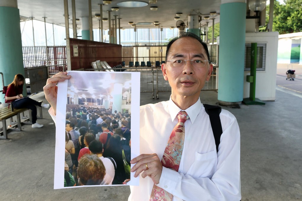 Lam Wai-man, a resident of Ma Wan, holding a photo of Tsuen Wan Pier after a barge hit Kap Shui Mun Bridge on Friday. Photo: Dickson Lee