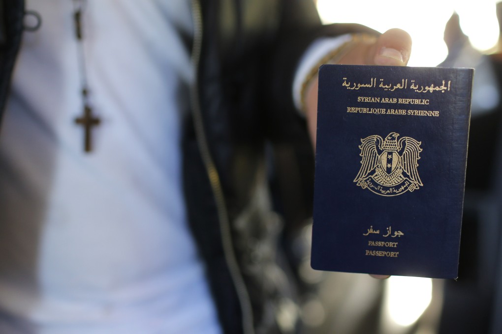 A Syrian refugee displays his passport at Charles-de-Gaulle Airport in France. Demand for the passports has soared, and netted the government much-needed revenue. Photo: Reuters