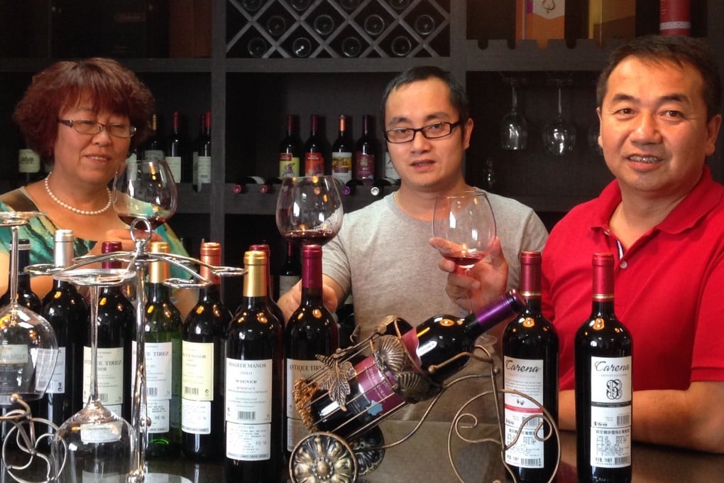 You Chao (centre) at a wine-tasting event with two of his clients in his office in Guangzhou. Photo: SCMP Pictures