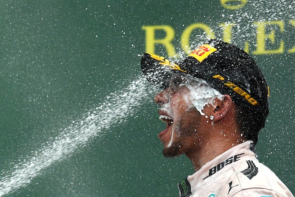 Mercedes driver Lewis Hamilton celebrates is saoked on champagne on the podium after winning the US Formula One Grand Prix at the Circuit of The Americas in Austin, Texas.  Photo: AFP