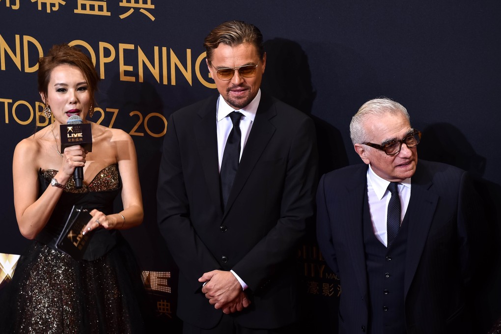 US actor Leonardo Di Caprio (centre) and US film director Martin Scorsese stand on the red carpet ahead of the opening ceremony of the Studio City casino resort in Macau on Tuesday. Casino operator Melco Crown was to open its latest resort Studio City as the city scrambles to diversify from gambling to the mass-market amid falling revenues. Photo: AFP