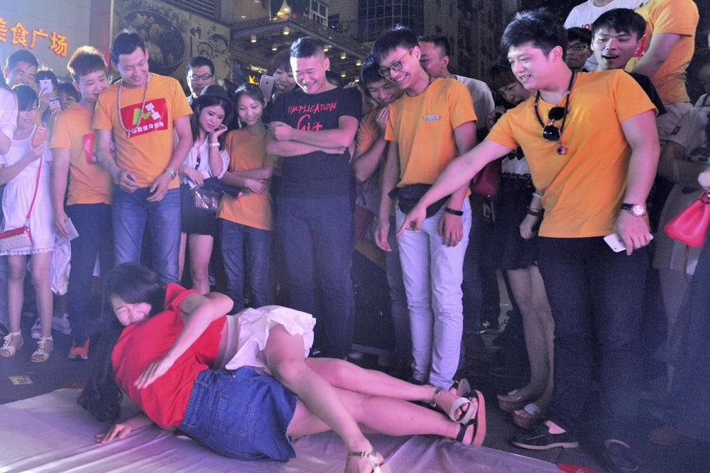 Chinese youths play a hugging game outside a department store in Jinhua, Zhejiang province to mark May 20, a nod to social media slang "520", which sounds like "I love you" in Putonghua. Photo: Corbis