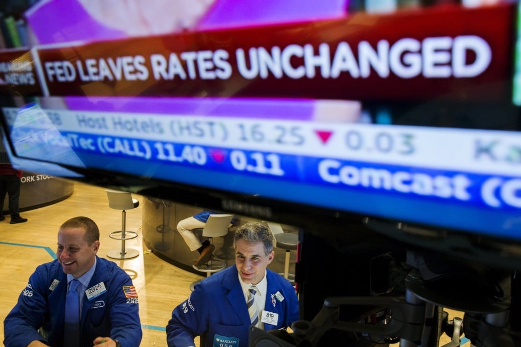 Traders in Wall Street scurry about after the news the US Federal Reserve left interest rates unchanged, as expected, but put a December rate hike in play. Photo: Reuters
