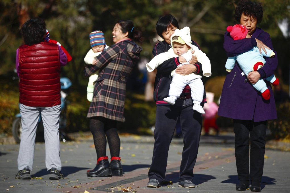 Parents and babies gather at a park in Beijing. Photo: EPA