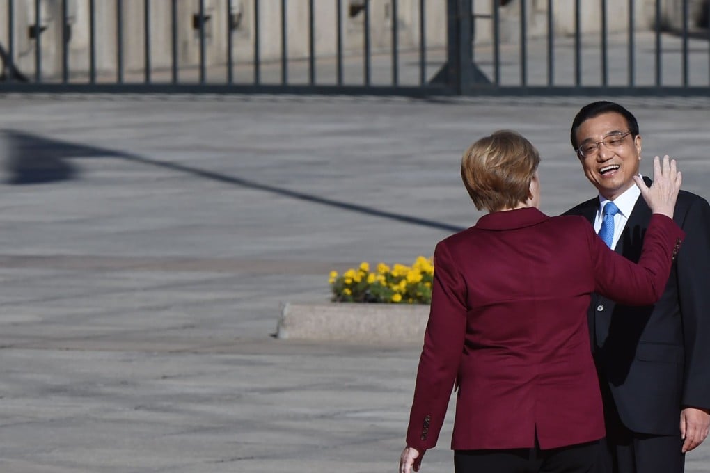 German Chancellor Angela Merkel chats with Chinese Premier Li Keqiang during a welcome ceremony outside the Great Hall of the People in Beijing on Thursday. Photo: AFP