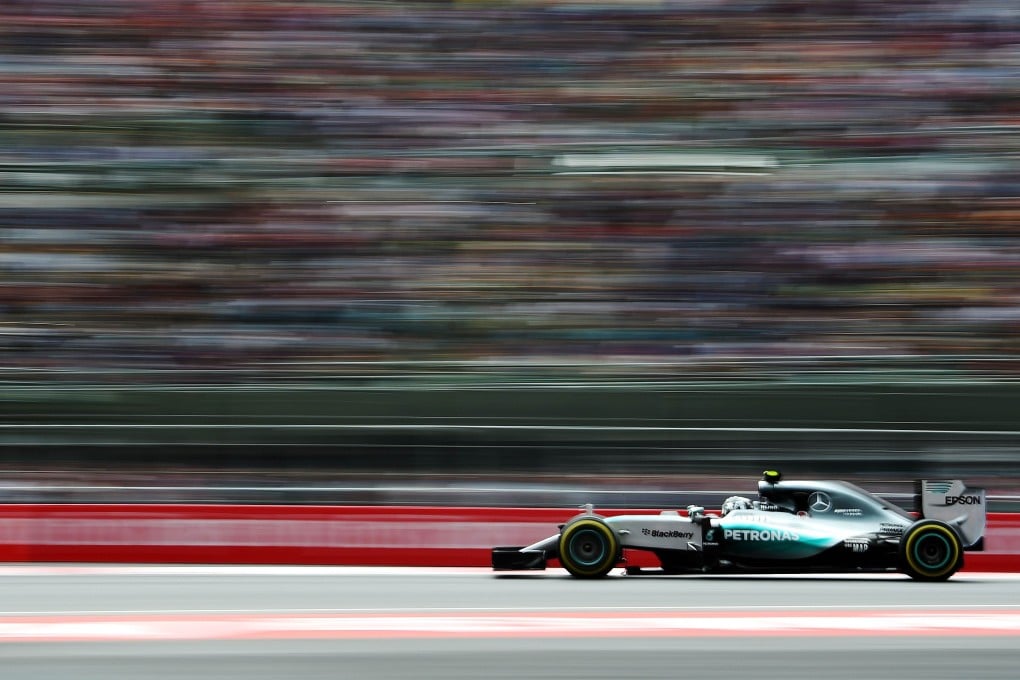 Nico Rosberg drives past one of the grandstands. Photo: AFP