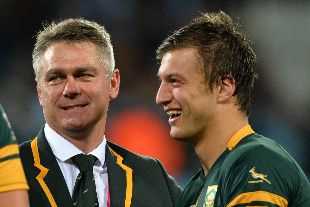 Heyneke Meyer speaks with fly-half Handre Pollard. Photo: AFP