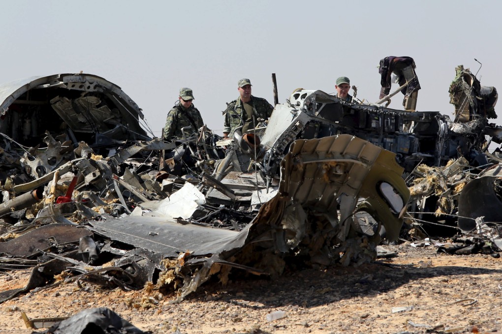 Military investigators from Russia stand near the debris of a Russian airliner at the crash site. Photo: Reuters