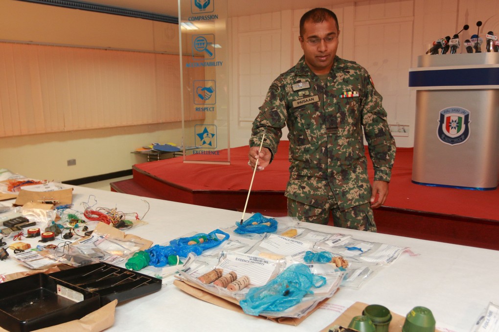 A Maldives officer inspects suspected bomb-making materials found on the seabed off an island in the Baa Atoll during investigations. Photo: Reuters