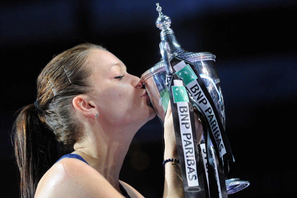Agnieszka Radwanska kisses her trophy after winning the WTA Finals title in Singapore. Photo: Xinhua