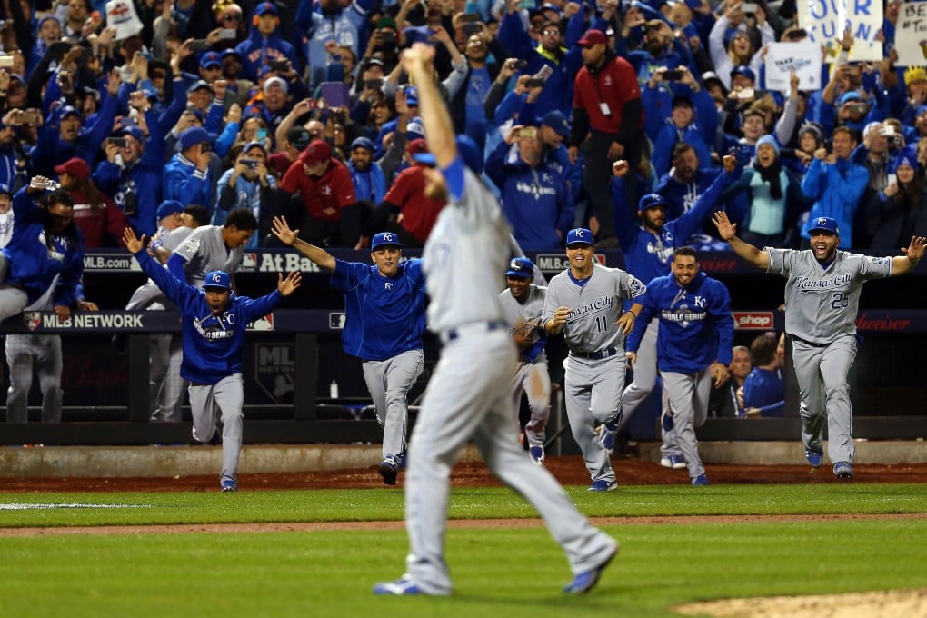 The Kansas City Royals dugout runs to the field to celebrate after defeating the New York Mets in Game Five of the 2015 World Series in New York. Photo: AFP