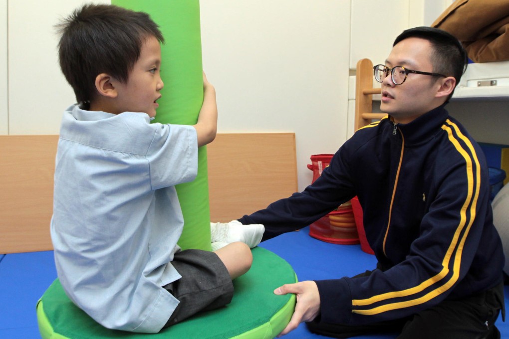 Six-year-old Yan Yan is helped by Steve Chan, a Rainbow Project occupational therapist. Photo: Bruce Yan