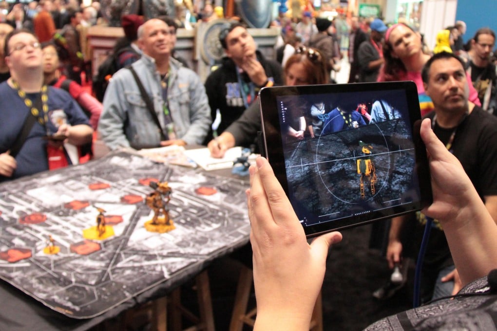 A demonstration of Giant Killer Robots, an augmented reality tabletop game that merges the digital and physical worlds. Photo: Weta Workshop