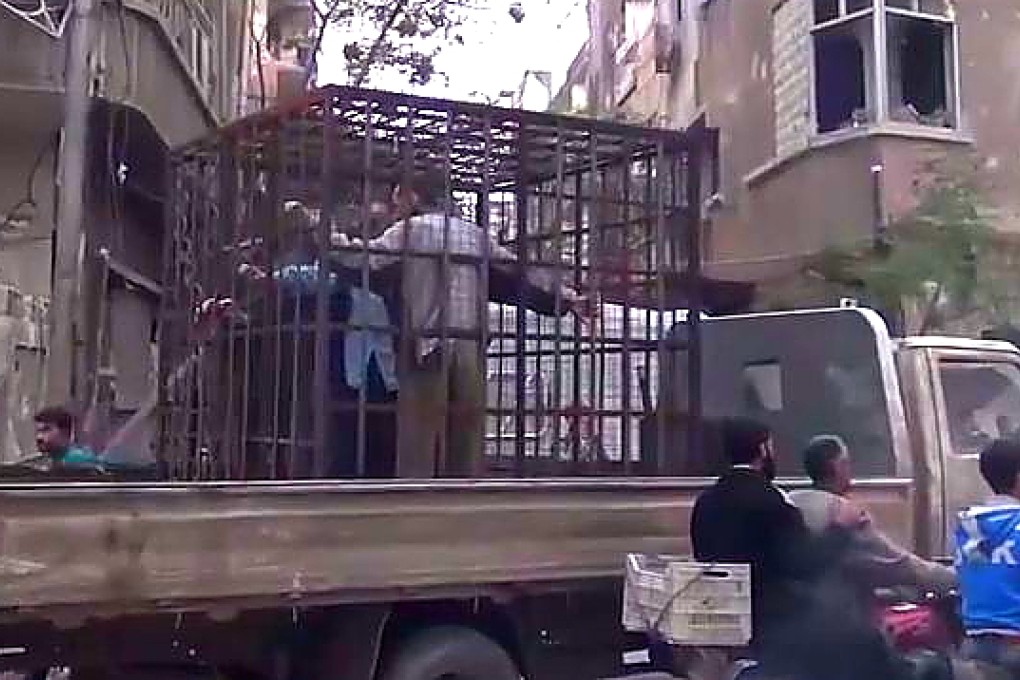 A still image taken from a video that purportedly shows prisoners in iron cages being driven through Eastern Ghouta in Syria. Photo: Shaam News Network